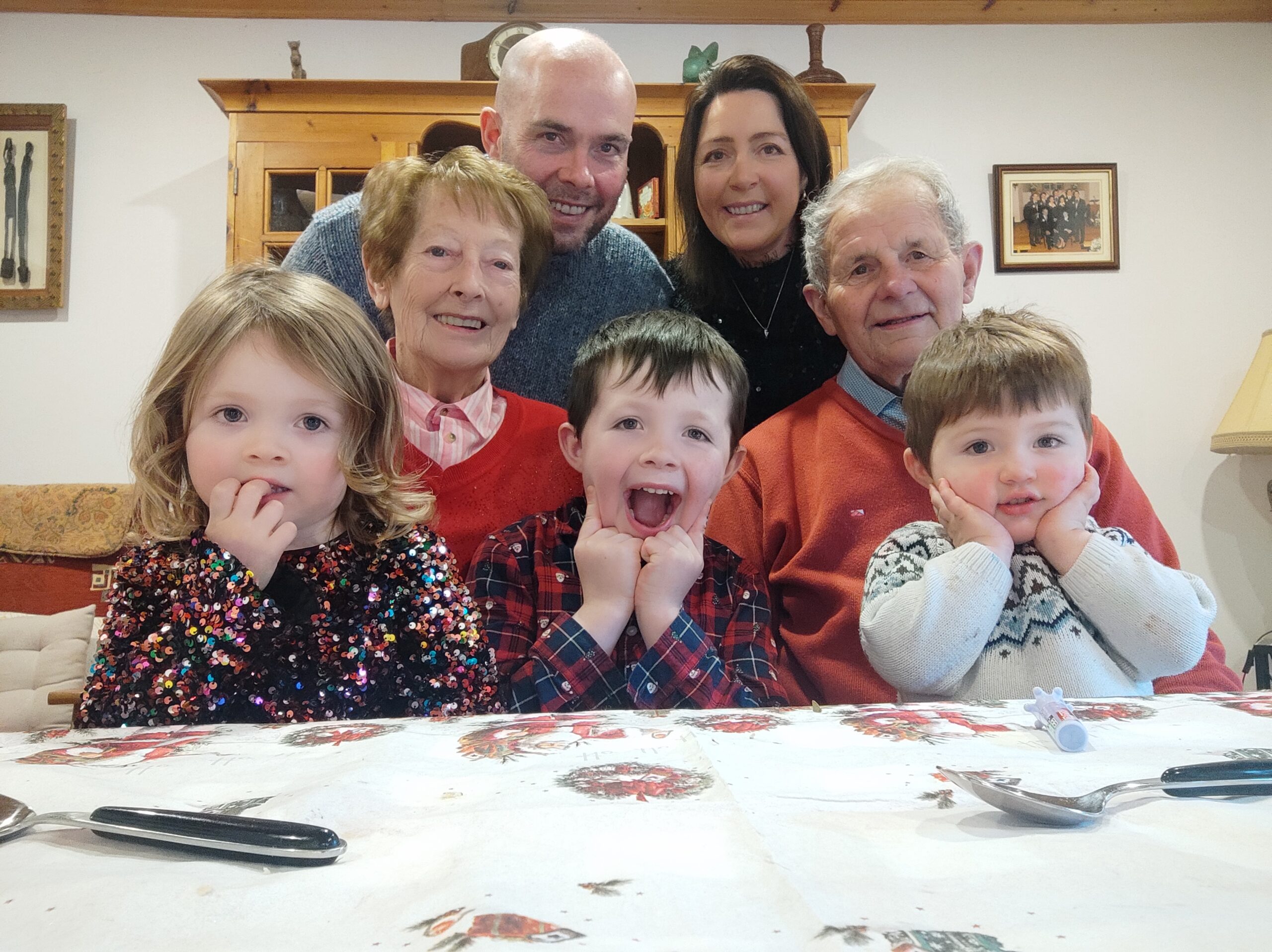 Kevin, Noreen and their kids with their grandparents posing for a family photo